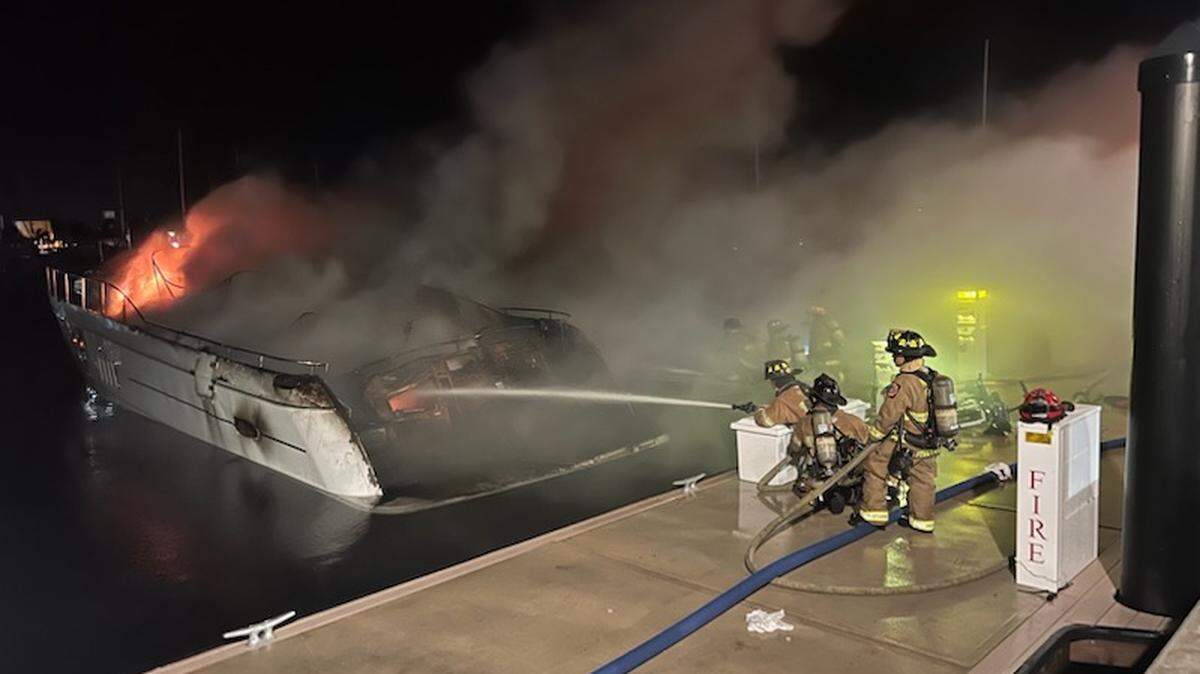 Monore County firefighters battle a blaze on a 70-foot yacht on Stock Island at the Peary Hotel Marina early Wednesday morning, July 26, 2023.