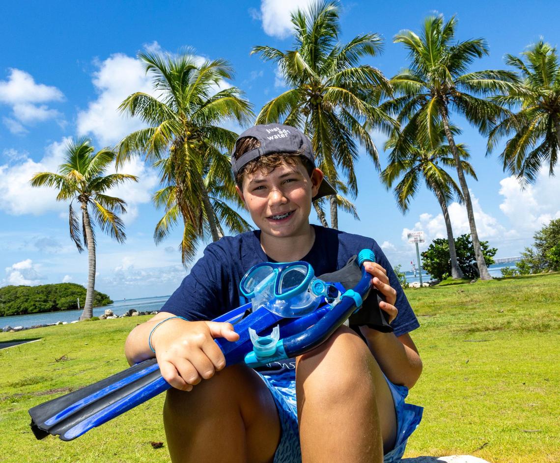 Master Diver Matteo Miller, 12, strikes a pose on Saturday, August 10, 2024, in Key Biscayne, Fla. Miller received the master diver certification after completing his Rescue diver certification.