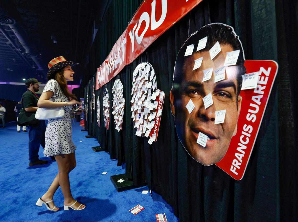 Isabella Bertolozzi, 21, looks over the comments posted on headshots of presidential candidates, including Miami Mayor Francis Suarez, seen at right, during the Turning Point Action Conference at the Palm Beach County Convention Center in West Palm Beach, Florida, on Saturday, July 15, 2023.