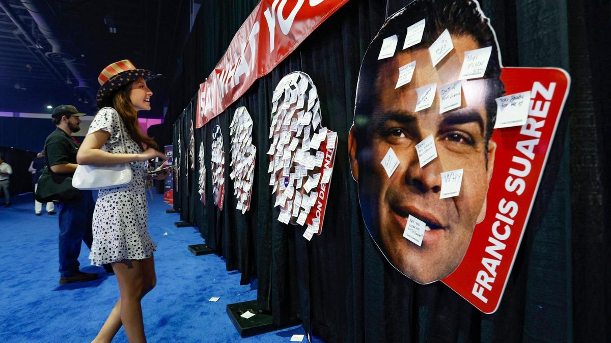 Isabella Bertolozzi, 21, looks over the comments posted on headshots of presidential candidates, including Miami Mayor Francis Suarez, seen at right, during the Turning Point Action Conference at the Palm Beach County Convention Center in West Palm Beach, Florida, on Saturday, July 15, 2023.
