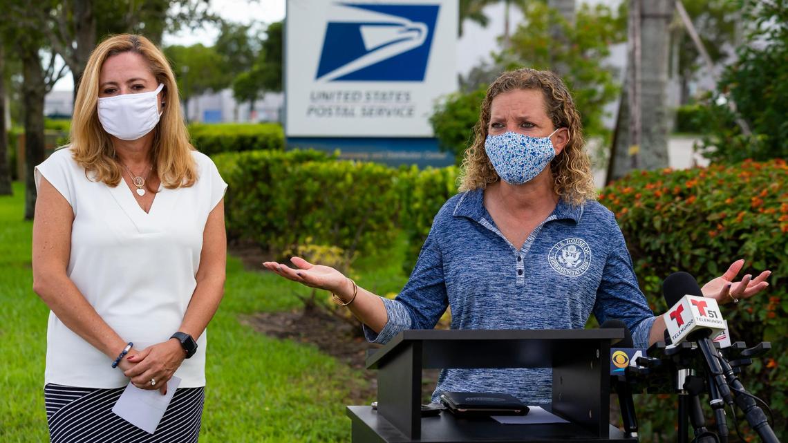Democratic U.S. Reps. Debbie Mucarsel-Powell, left, and Debbie Wasserman Schultz speak during a press conference near the United States Postal Service mail distribution facility in Opa-locka, Florida on Tuesday, August 18, 2020. Democrats spoke about their plans to protect the USPS and how they will work to ensure access to the ballot during this election season.