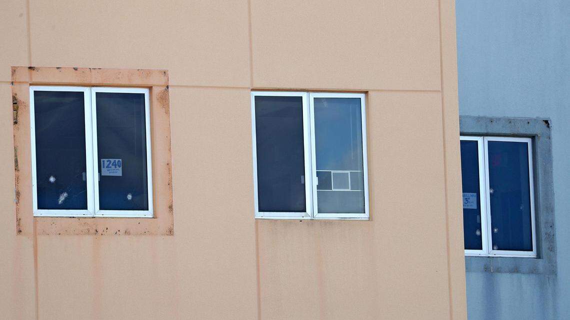 A sign reading ’1240 west facing window’ and five bullet holes can be seen in a third-floor window of the 1200 building at Marjory Stoneman Douglas High School in Parkland on Aug. 4, 2022. The freshman building is where 17 students and faculty members were shot to death on Feb. 14, 2018.
