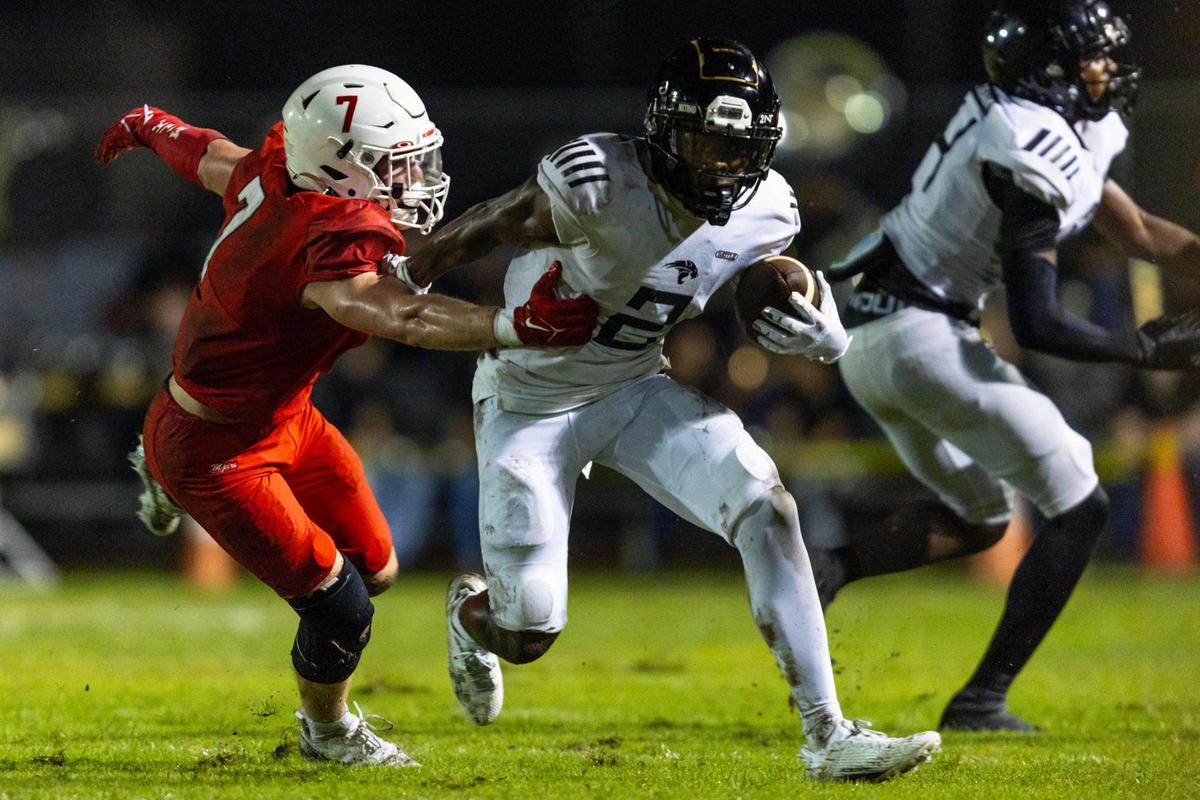 Western wide receiver Koby Howard (2) runs with the ball after a reception while defended by Milton High linebacker Jack Lawson (7) during the 2023 Broward County National Football Showcase at Western High School in Davie, Florida, on Thursday, August 24, 2023.