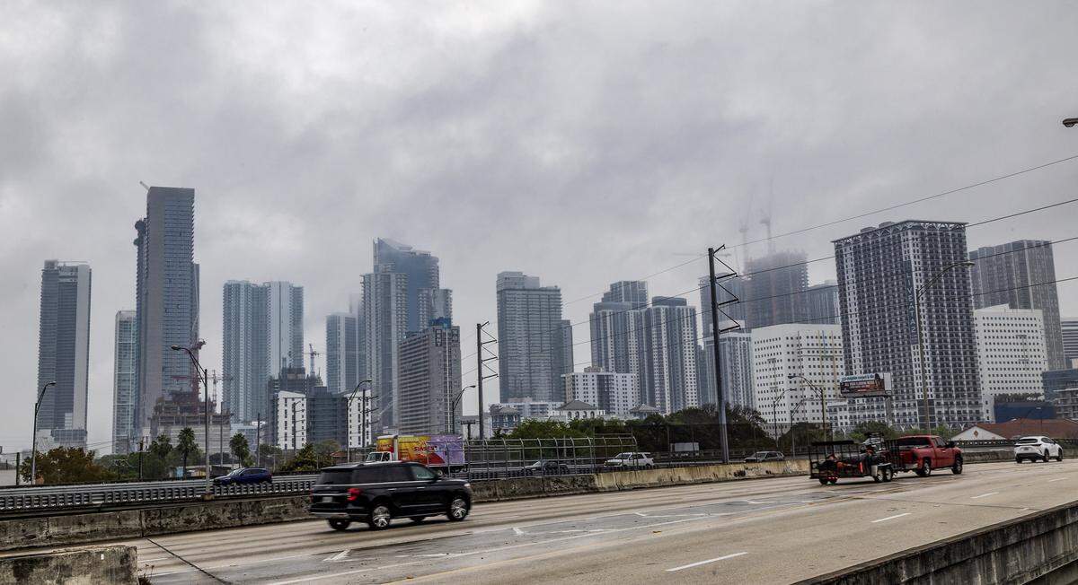 Low clouds hover around the top of Miami skyline buildings in the morning as the National Weather Service predicts rain chances near 50%, during the afternoon, on Wednesday, March 18, 2026.