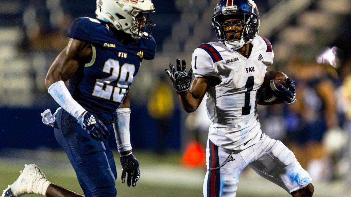 FAU wide receiver LaJohntay Wester (1) runs the ball while chased by FIU defensive back Jamal Potts (29) during the Shula Bowl at Riccardo Silva Stadium in Miami, Florida, on Saturday, November 12, 2022.