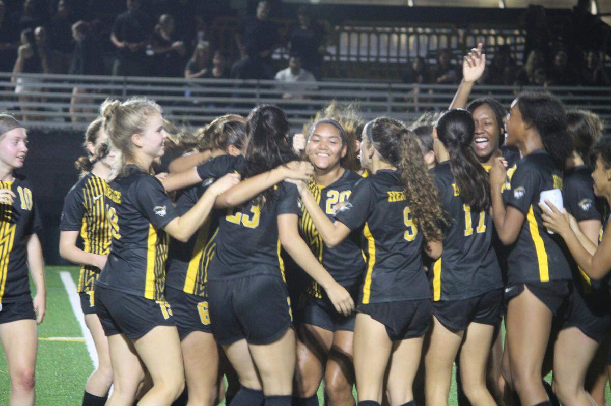 American Heritage’s girls’ soccer team celebrates its victory in the Class 5A state semifinals on Friday night.