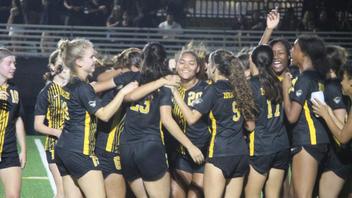 American Heritage’s girls’ soccer team celebrates its victory in the Class 5A state semifinals on Friday night.