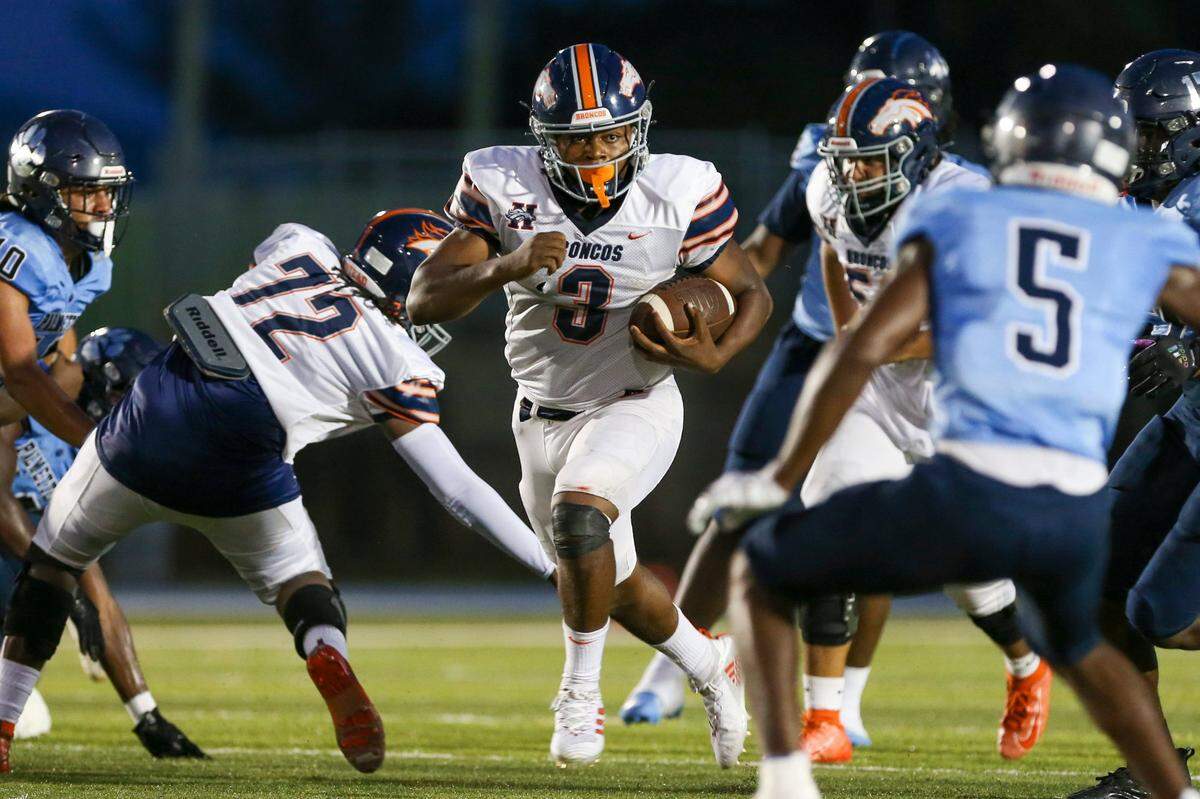 Homestead Broncos quarterback Joshua Townsend (3) runs with the football during the second quarter of a high school football game against the Palmetto Panthers at Tropical Park Stadium in Miami, Florida, Thursday, August 25. 2022.