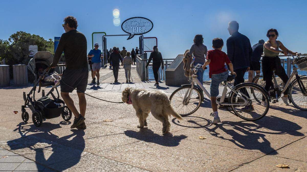 Beach goers enjoy the weather walking by the South Pointe Park Pier in South Beach early morning on January first, 2026, as South Florida experience sunny, clear conditions with highs in the mid-to-upper 60s and lows in the upper 30s to lower 40s on Thursday, January 01, 2026.