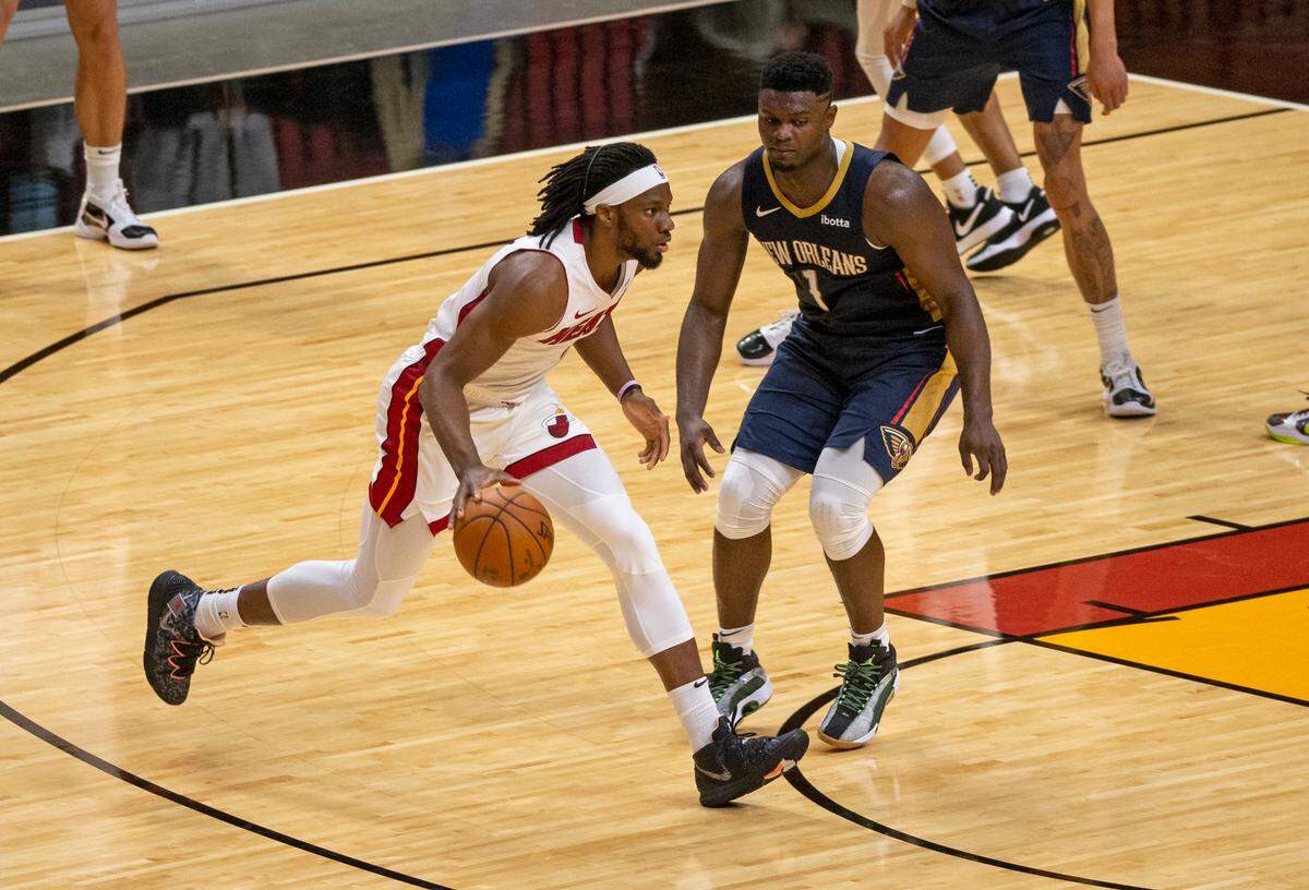 Miami Heat forward Precious Achiuwa (5) drives against New Orleans Pelicans forward Zion Williamson (1) in the third quarter of an NBA basketball preseason game at the AmericanAirlines Arena on Monday, Dec. 14, 2020.