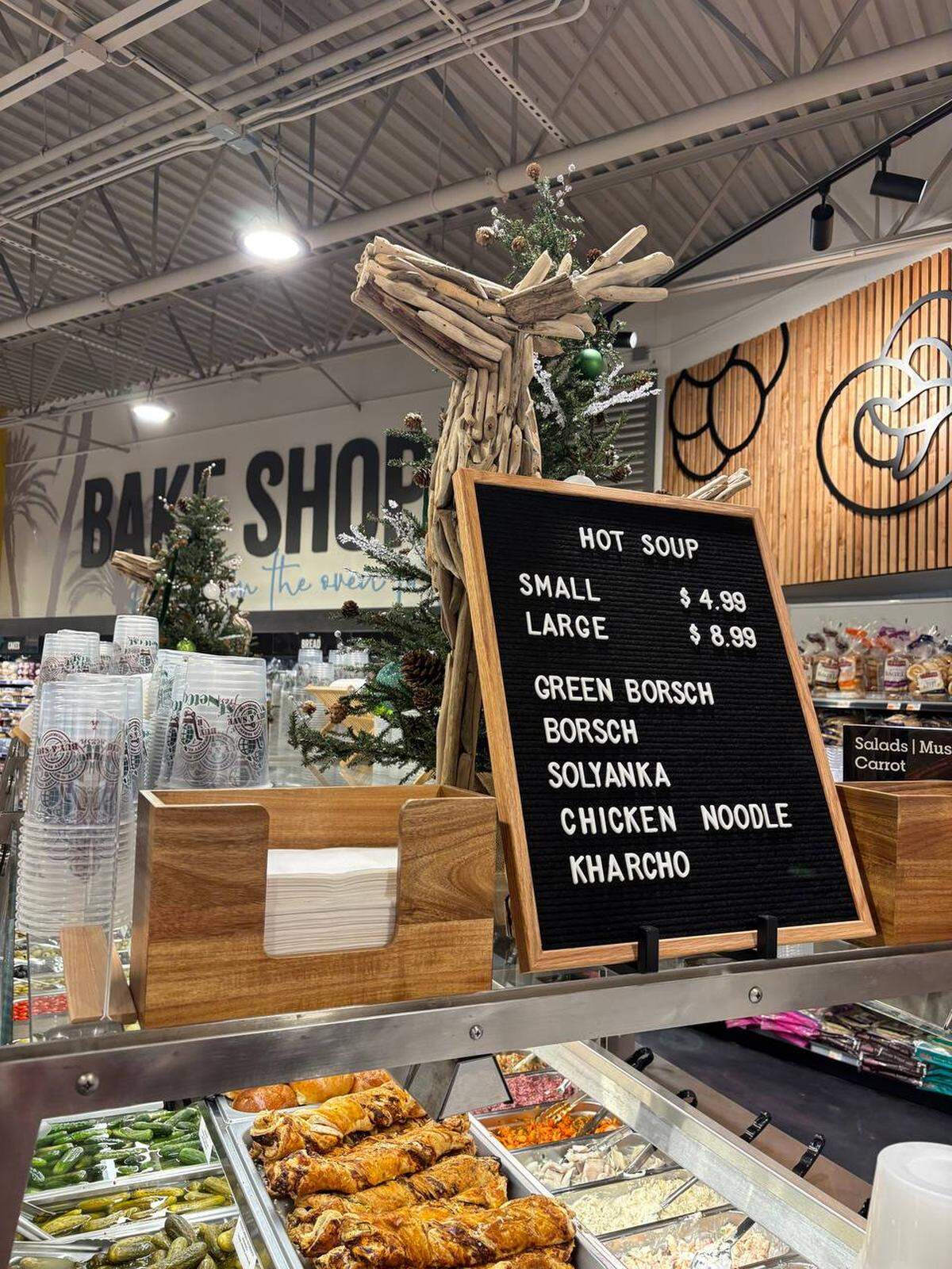 A prepared foods department and hot soup station at a NetCost Market. Here you may find green and red borsht, solyanka (a combination of sausage, cured meats, rich broth, olives, capers that is popular in Russia and Ukraine), chicken noodle and kharcho (a traditional Georgian soup containing beef, rice, cherry plum purée and chopped walnuts.)
