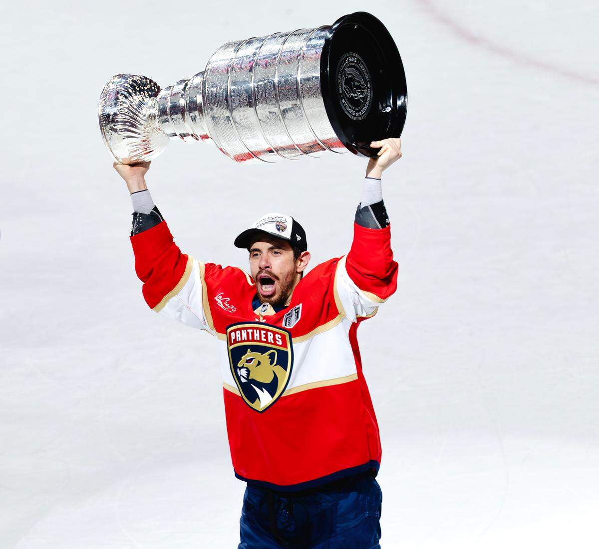 Florida Panthers center Evan Rodrigues (17) lifts the Stanley Cup after defeating the Edmonton Oilers 5-1 in Game 6 of the Final at Amerant Bank Arena in Sunrise, Fla., on Tuesday, June 17, 2025, clinching the NHL championship.