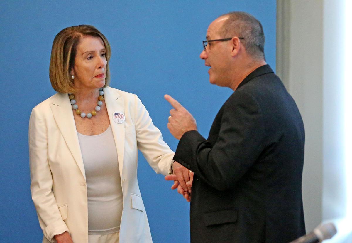 Democratic Leader Nancy Pelosi talks with Fred Guttenberg, a parent of one of the Marjory Stoneman Douglas HS victims, before a round table discussion on guns and voting in Coral Springs, Florida, Oct. 17, 2018.