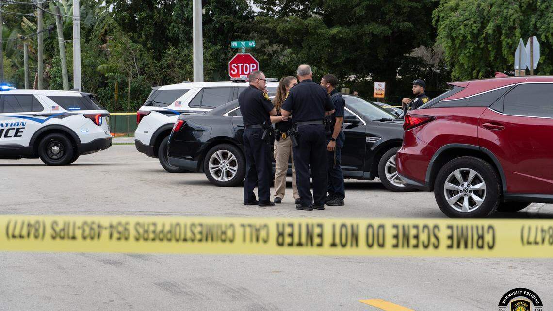 Police officers stand near where a teen was shot and wounded in Plantation Monday afternoon, Dec. 8, 2025.