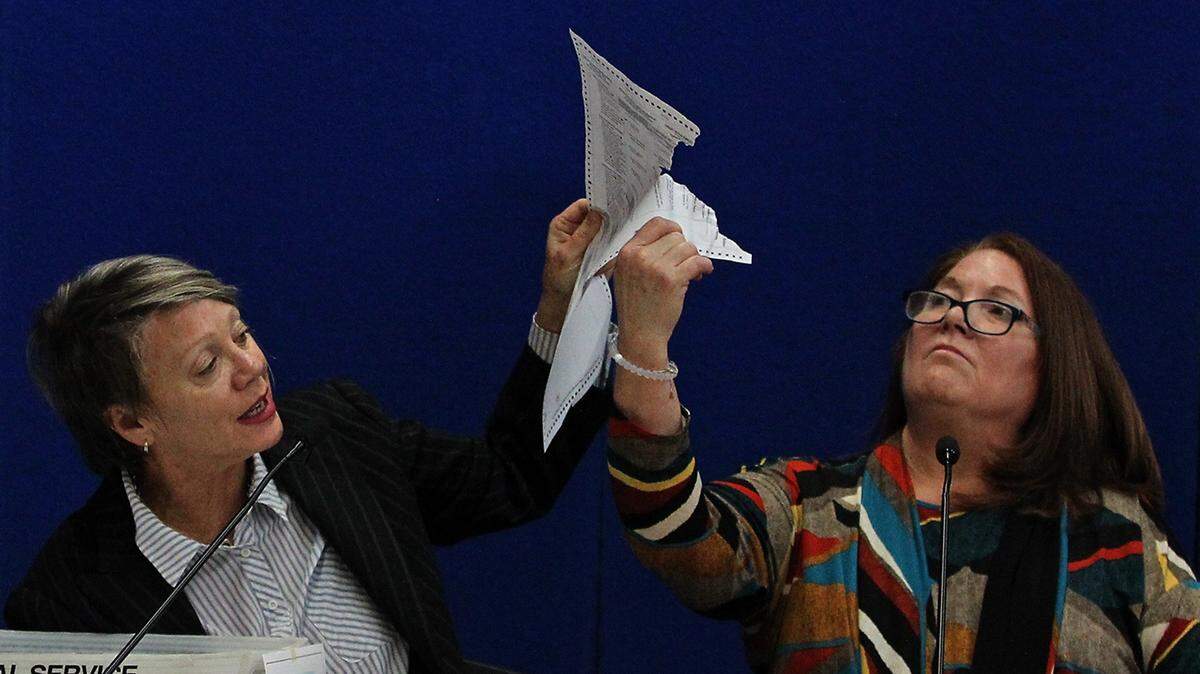 Judge Betsy Benson, canvassing board chair, left, and Judge Deborah Carpenter-Toye, canvassing board member, examine a damaged ballot during the election recount in Broward County on Nov. 14, 2018.