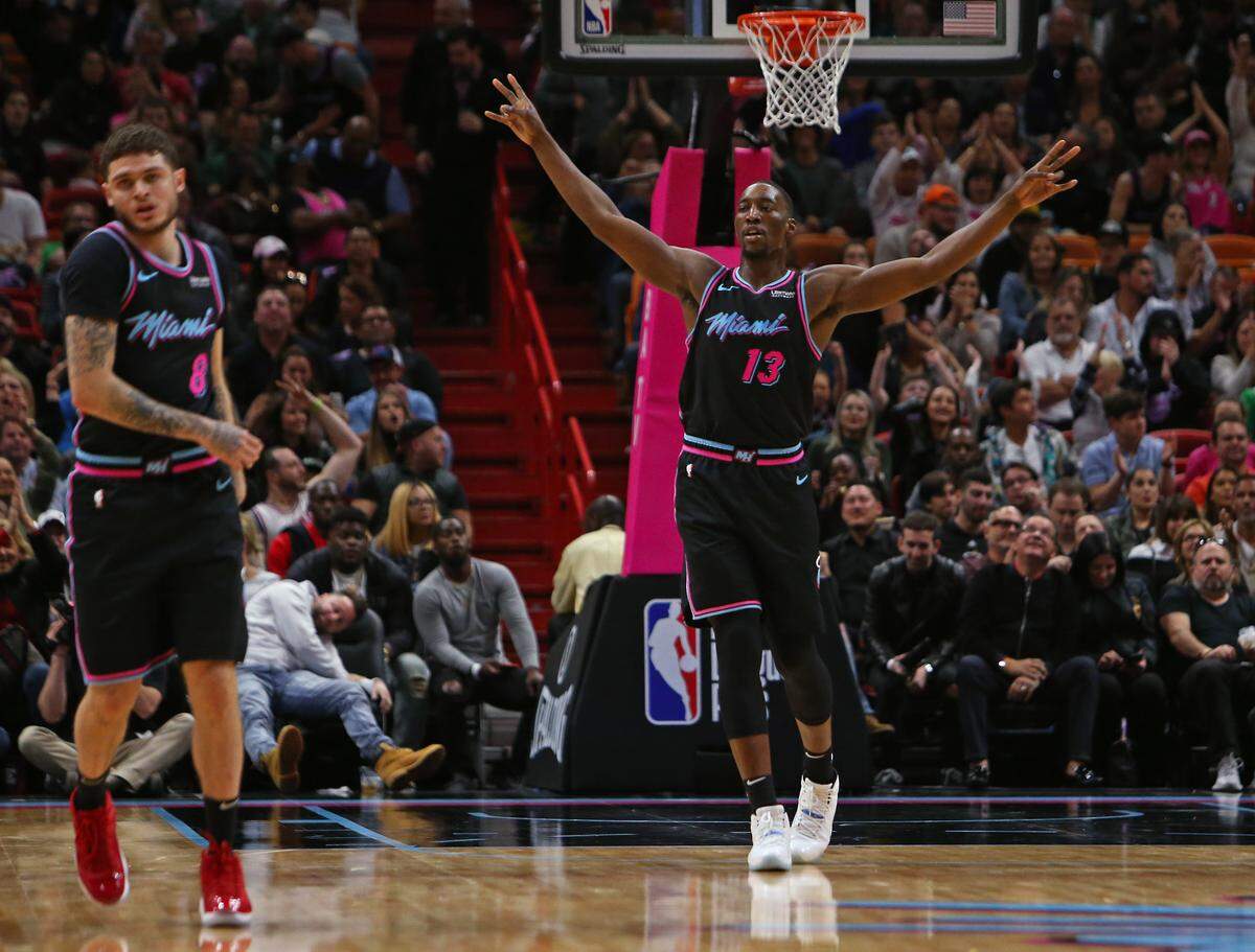 Miami Heat forward Bam Adebayo (13) reacts after Tyler Johnson (8) hitting a three pointer in the fourth quarter of an NBA basketball game against the Boston Celtics at AmericanAirlines Arena on Thursday, January 10, 2019 in Miami.