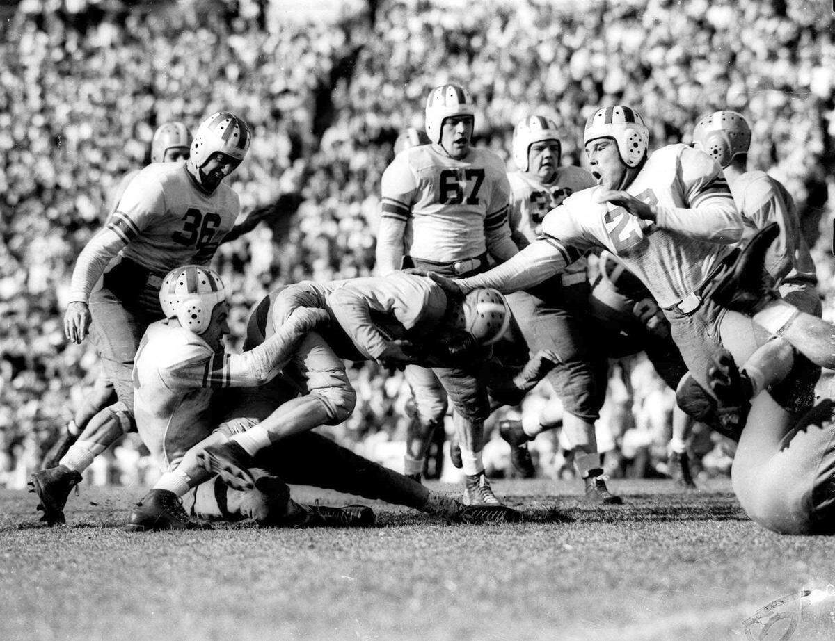 Buist Warren of Tennessee is thrown for a five-yard loss by Hugh McCullough, an Oklahoma back, in the Orange Bowl in Miami on Jan. 2, 1939.