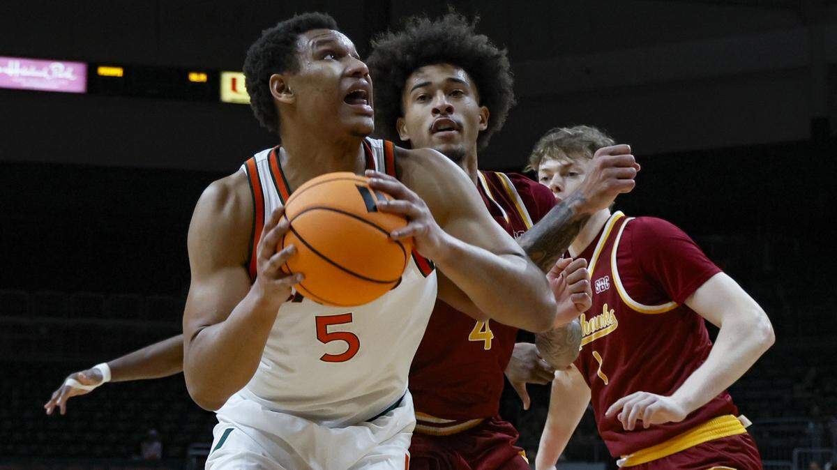 Miami Hurricanes forward Malik Reneau (5) looks towards the basket as ULM Warhawks forward Renars Sondors (5) defends in the first half against the ULM Warhawks during their NCAA basketball game at Watsco Center, at the University of Miami campus in Coral Gables, Florida on Saturday, December 13, 2025.