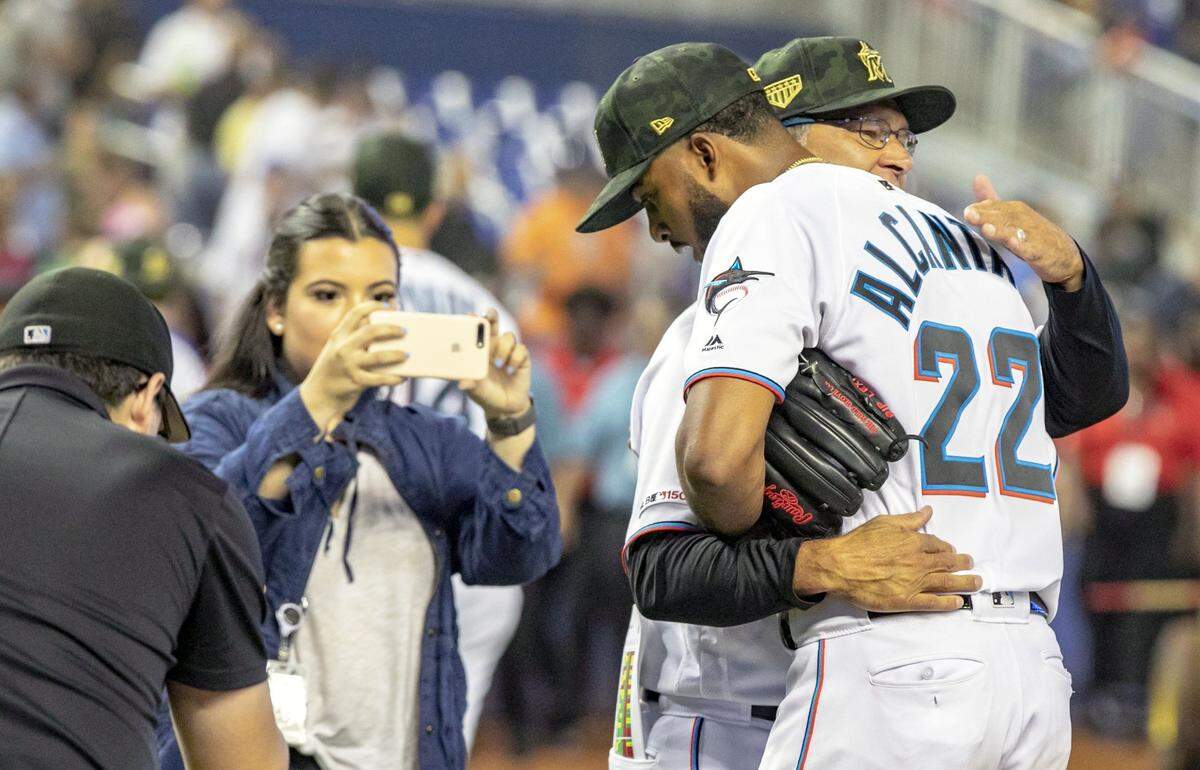 Miami Marlins Manager Don Mattingly (8) hugs Marlins pitcher Sandy Alcantara (22) after he completed the game against the New York Mets at Marlins Park in Miami, Florida, on Sunday, May 19, 2019. The Miami Marlins swept the New York Mets in the three game series.