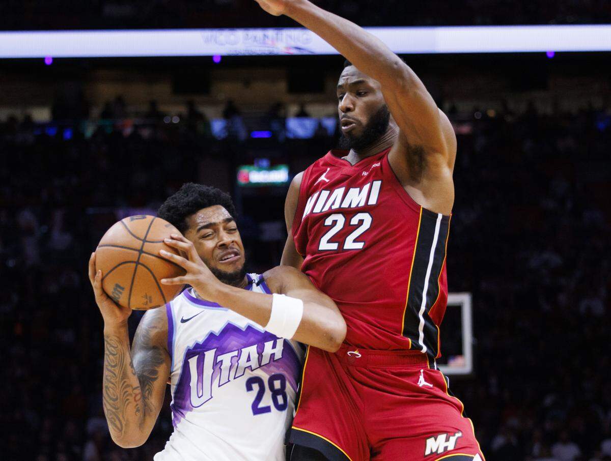 Utah Jazz forward Brice Sensabaugh (28) drives by Miami Heat forward Andrew Wiggins (22) during the first half of a game on Feb. 9, 2026, at Kaseya Center in Miami.