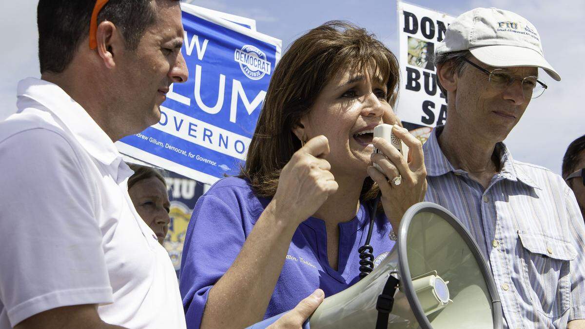 State Sen. Annette Taddeo stands next to State Rep. Javier Fernandez, left, as she speaks to the crowd at a Democrat rally against gun shows held at the Miami-Dade Youth Fair in Miami on Saturday, Sept. 1, 2018.