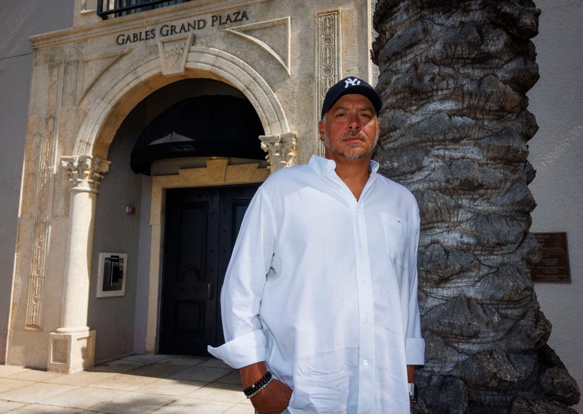 Frank Andreu, former resident at Gables Grand Plaza Apartments and local business owner, poses out front on Wednesday, July 31, 2024, in Coral Gables. In 2022, Andreu’s rent was increased by 25%.