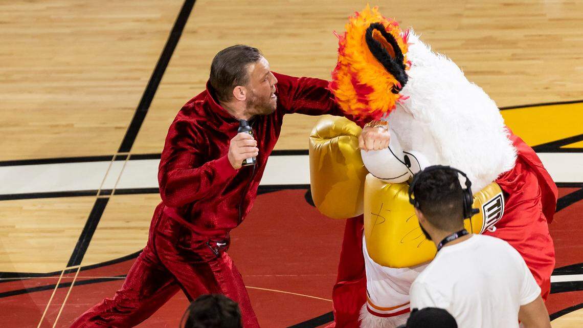 Mixed martial arts fighter Conor McGregor swings at Miami Heat mascot Burnie during a timeout period in Game 4 of the NBA Finals between the Miami Heat and the Denver Nuggets at the Kaseya Center on Friday, June 9, 2023, in downtown Miami, Fla.