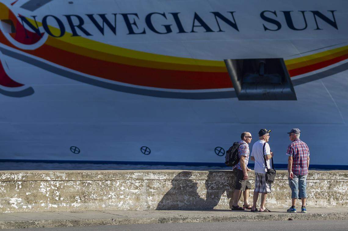 Tourists talk near the Norwegian Sun docked at the port in Old Havana. Twenty-five cruise ships now call in Cuba.