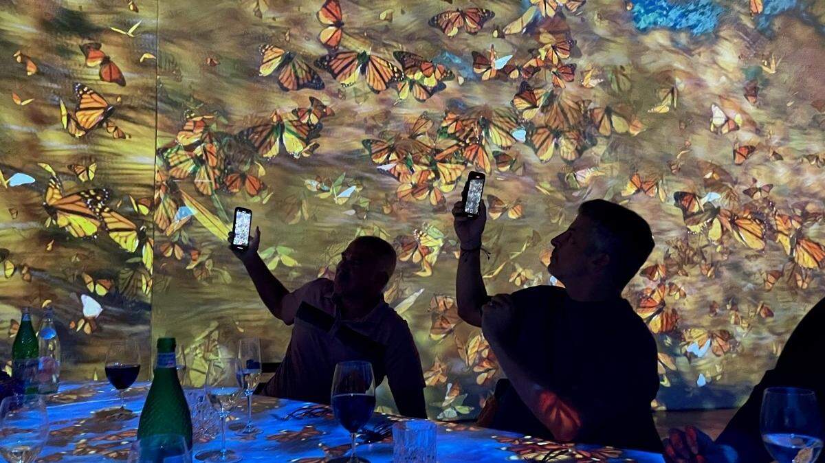 Guests at the first “Hidden Worlds” immersive dinner amid a storm of butterflies. The experience is returning to Miami in 2023.