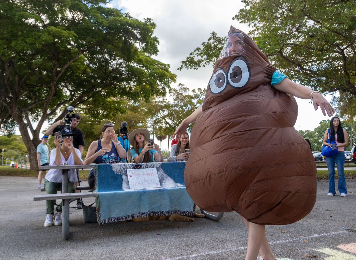 Debris Free Oceans team member dresses up as a blow-up pile of poop to remind people to pick up their dog poop. The poop can run-off into the ocean after heavy rains, and contribute to algal blooms and fish kills.