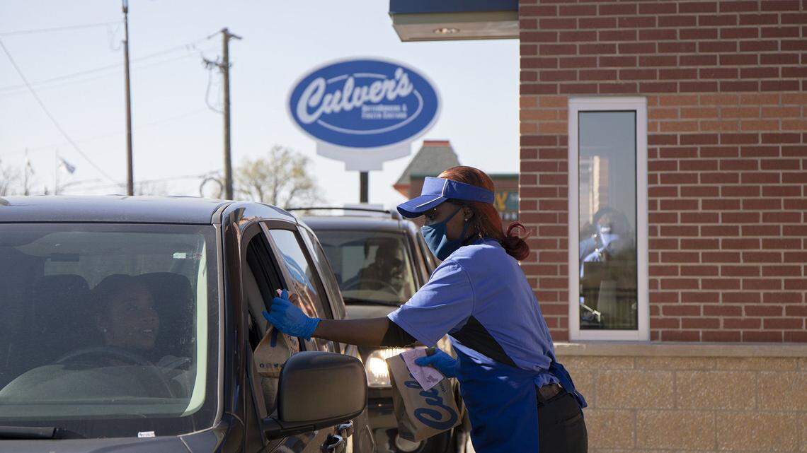 Culver’s employee Teesha Nelson hands a drive-thru customer their order on Nov. 8, 2021, outside the restaurant chain’s newest location in Pullman on its opening day.