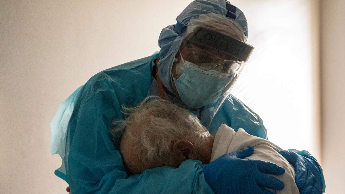 On Thanksgiving Day, Dr. Joseph Varon comforts a despairing elderly patient in the COVID-19 intensive care unit at the United Memorial Medical Center in Houston, Texas.
