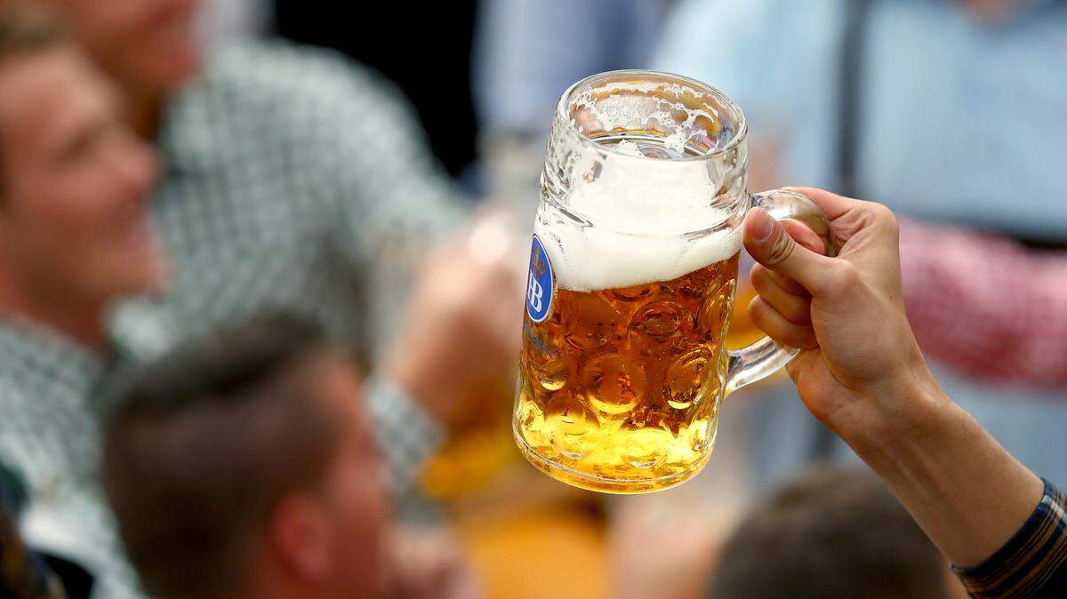 A guest holds glasses of beer during the opening of the 186th Oktoberfest beer festival in Munich, Germany, on Sept. 21, 2019.