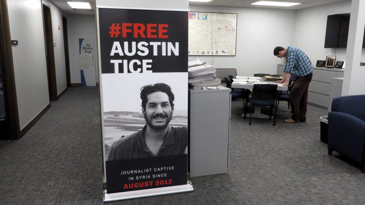 A poster in the newsroom of The Wichita Eagle calls for the release of Austin Tice, a freelance journalist working for McClatchy and other media in Syria when he was abducted in 2012.