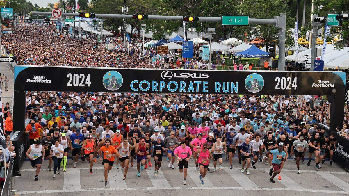Runners take off from the starting line in front of Bayfront Park on Biscayne Boulevard heading south. The annual 5K race is referred to as “South Florida’s Largest Office Party” with over seventeen thousand registered runners and hundreds of companies represented.