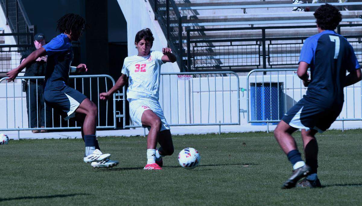 Doral Academy freshman midfielder Mateo Guzman works the ball through the Lake Nona defense during the first half of a Class 7A semifinal at the FHSAA state tournament Monday at Lake Myrtle Sports Park in Auburndale.