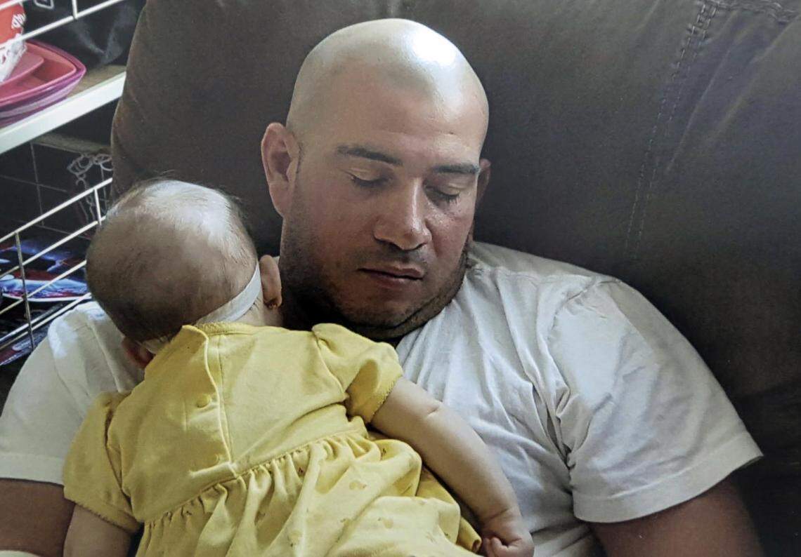 Family photo of Oscar Roberto Hernández, who had fallen asleep with a child. María Eugenia Hernández has been staying at her sister’s house ever since her husband, Oscar, was apprehended by ICE when they both showed up for an USCIS marriage interview in Miami.