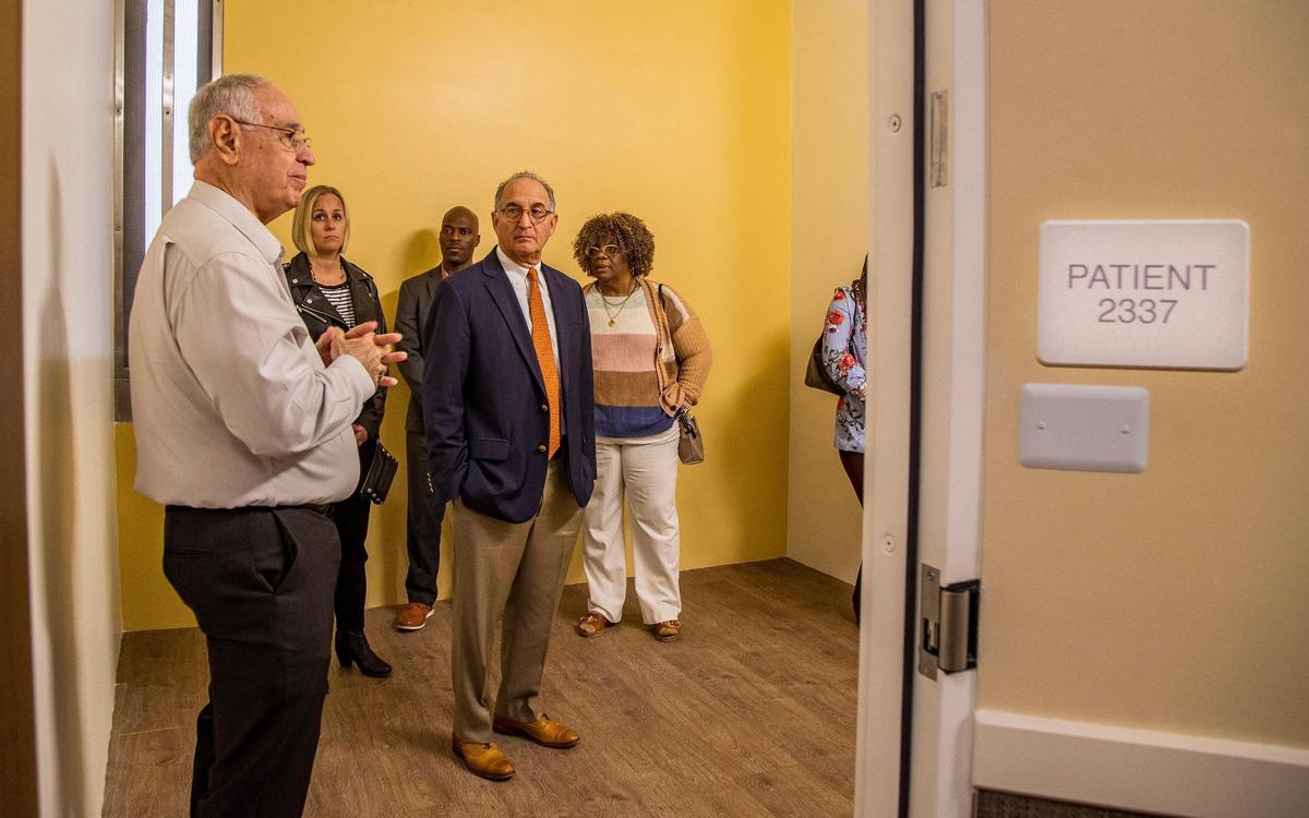 Consultant John W. Dow, far left, and Judge Steve Leifman, center, lead a tour of the not-yet-opened Miami Center for Mental Health and Recovery at 2200 NW Seventh Ave..