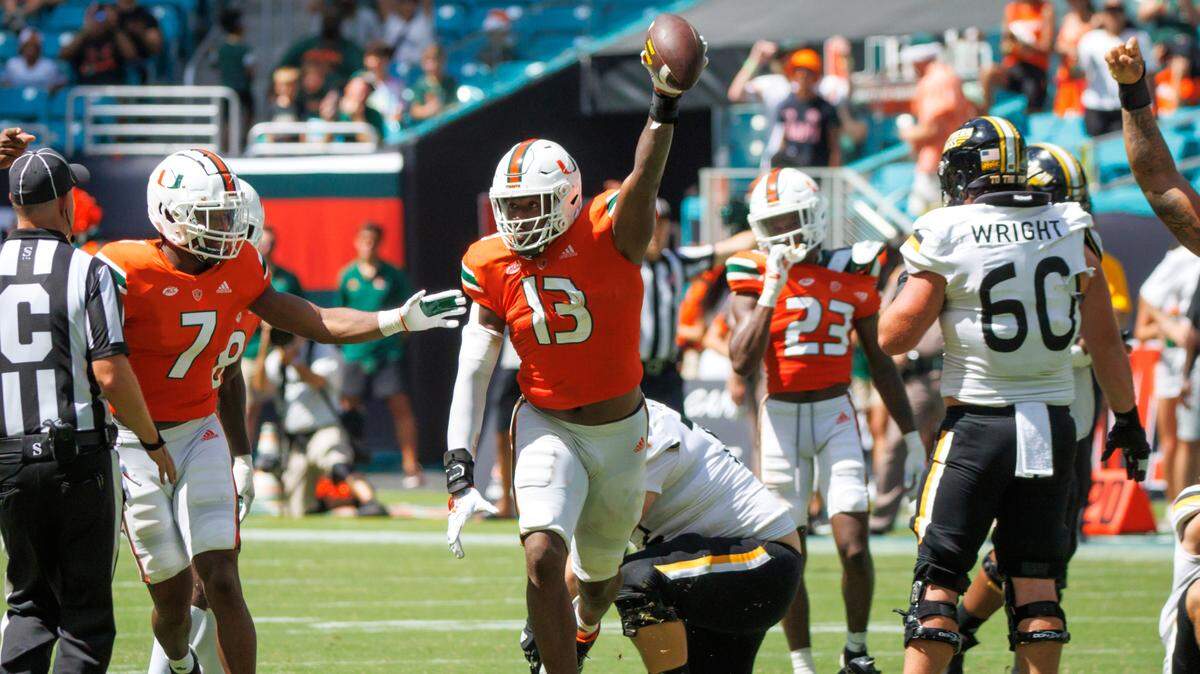 Miami Hurricanes defensive line Chantz Williams (13) celebrate with teammates after recovering a fumble during the fourth quarter of an NCAA non conference game against Southern Miss Golden Eagles at Hard Rock Stadium on Saturday, September 10, 2022 in Miami Gardens, Florida.