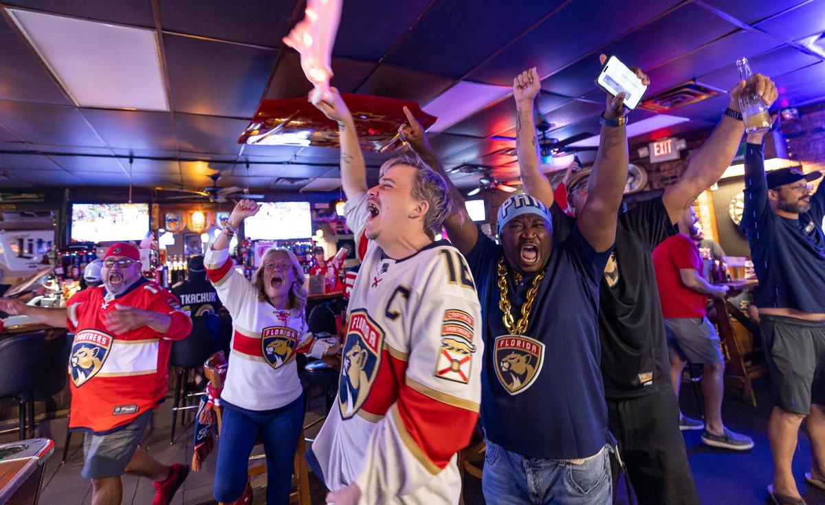 Florida Panthers fan Chris Miller, center, cheers after his team scored against the Edmonton Oilers in Game 2 of the NHL Stanley Cup Final at the Inn Field Bar & Grill on Friday, June 6, 2025, in Sunrise, Fla.