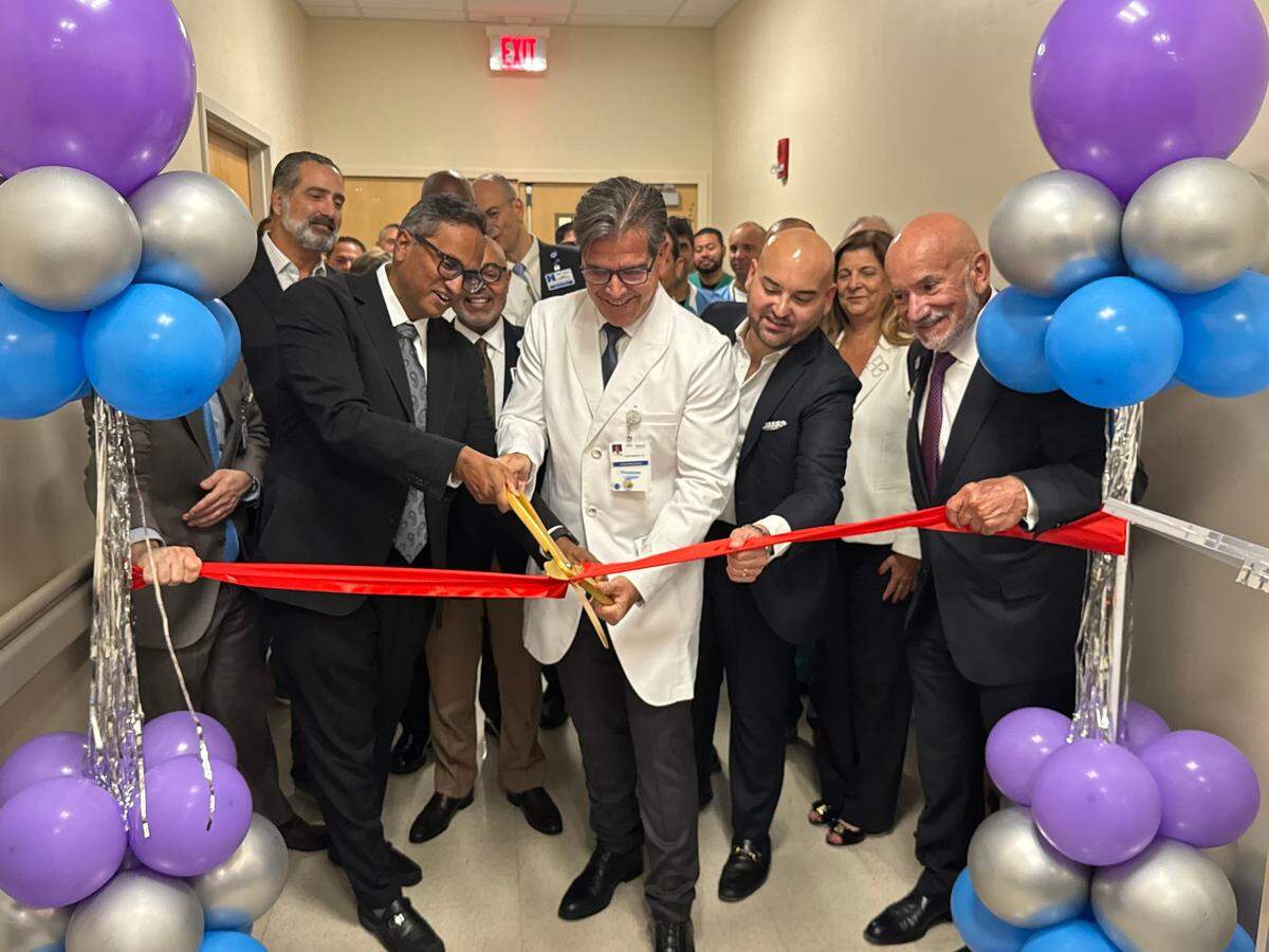 Doctors and Jackson executives gather together for a ribbon-cutting ceremony celebrating the newly renovated catherization lab at Jackson South Medical Center in south Miami-Dade on Tuesday, June 22, 2025. In the front row (from left to right) are Dr. Hari Mallidi, the chief of cardiac surgery and director of the Jackson Heart Institute; Dr. Juan Zambrano, director of cardiovascular medicine at Jackson South Medical Center; Eddie Borrego, senior vice president and chief executive officer of Jackson South and Jackson West; and Carlos Migoya, chief executive officer of Jackson Health System.