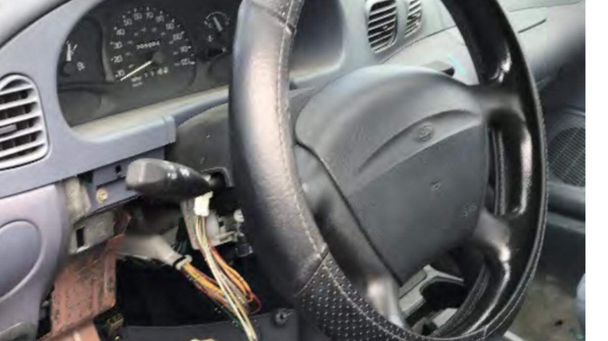 Exposed wiring dangles from underneath the steering column of a car belonging to Miami-Dade County Public Schools for its driver education program.