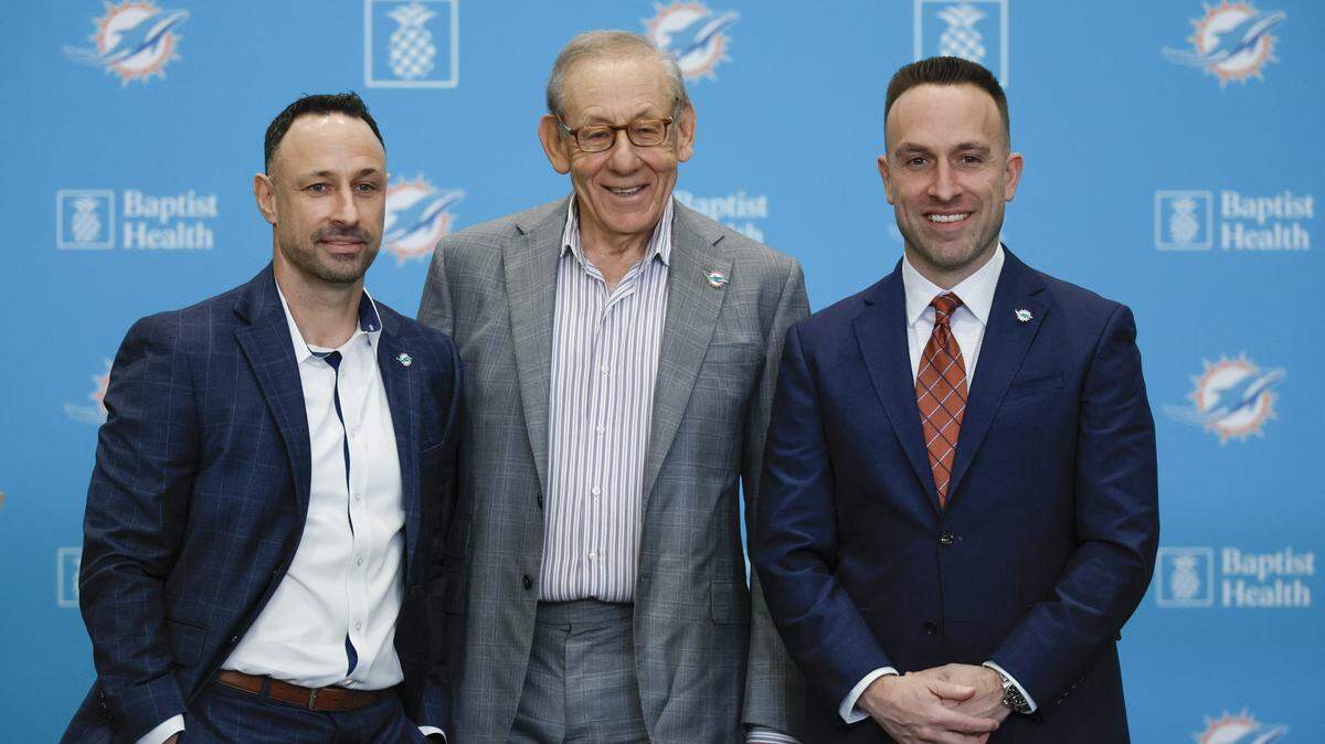 Miami Dolphins Chairman and Managing General Partner Stephen M. Ross, at center, introduces the new General Manager Jon-Eric Sullivan, at left, and Head Coach Jeff Hafley, at right, during a press conference at the Baptist Health Training Complex in Miami Gardens, Florida, on Thursday, January 22, 2026. 
