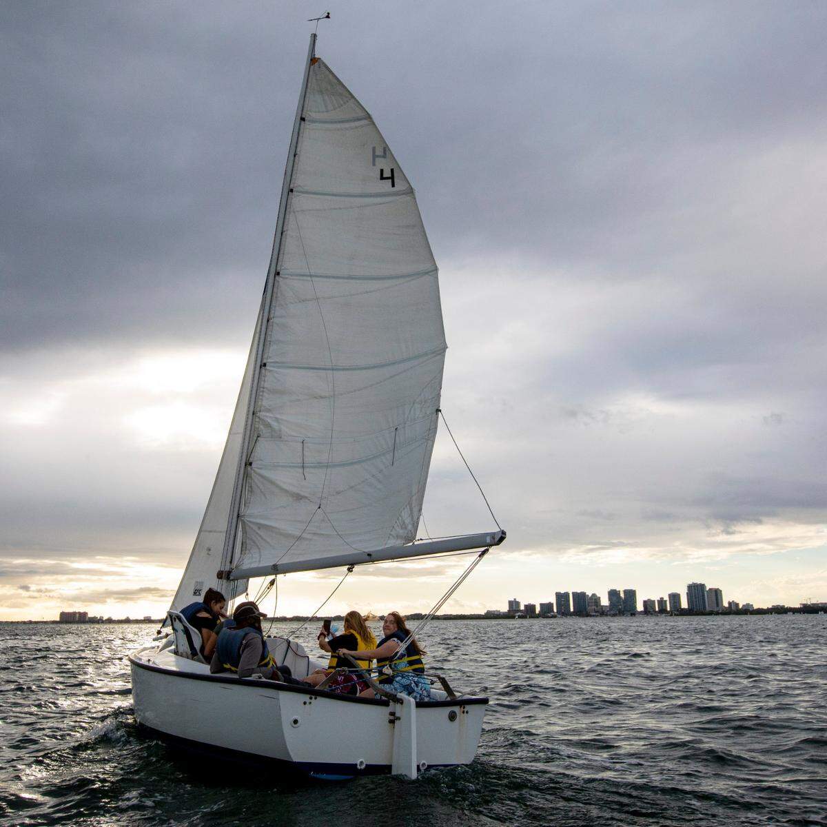 Veteran sailor Donaray Bickham, 60, maneuvers the waters with Julieta Romano, 55, her oldest daughter Martina Gigante, 26, younger daughter, Julieta Galdames, 15, and her friend Annelyse Soto, 15, as they enjoy a sail out on Biscayne Bay on Wednesday, Feb., 24, 2021.