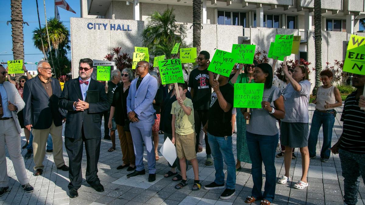 Residents of North Miami rally in front of North Miami City Hall on Feb. 21, 2023. A lawsuit was filed seeking to force North Miami to hold its May 2023 elections. This comes months after the city council decided to move the election date and extend council members’ terms, which the lawsuit says is a violation of the city’s charter. The mayor, Alix Desulme, and longtime councilman Scott Galvin are named in the lawsuit.