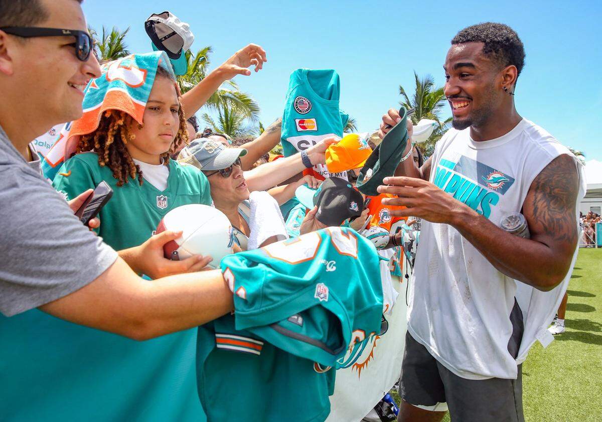 Miami Dolphins wide receiver Jaylen Waddle signs autographs after practice at Baptist Health Training Complex in Miami Gardens on Saturday, July 30, 2022.