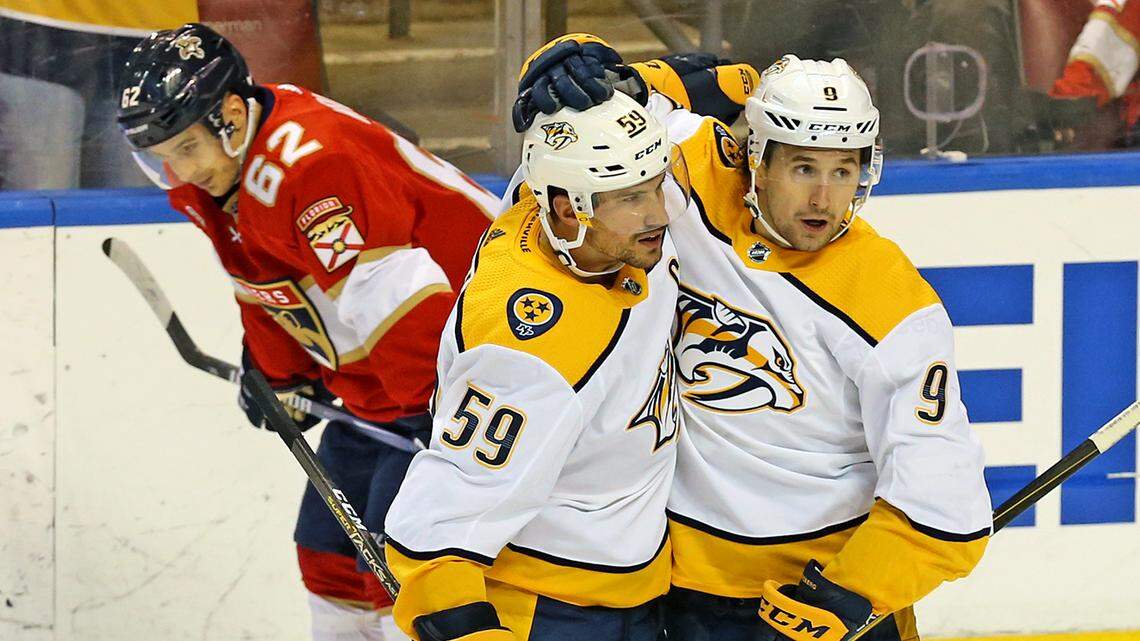 Florida Panthers Denis Malgin (62) slumps over as Nashville Predators Roman Josi (59) celebrates with Filip Forsberg (9) after Josi scored to tie the game as they play the Panthers in the third period at the BB&T Center in Sunrise, Florida, Friday, February, 1, 2019.
