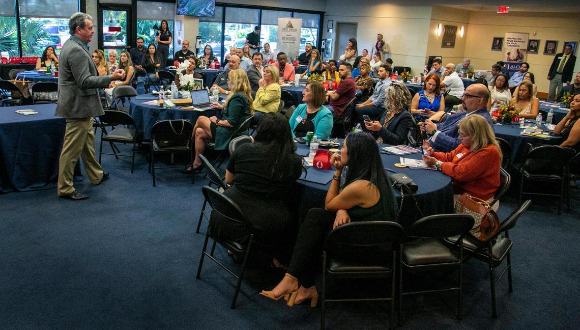 Mayor Tim Meerbott, left, speaks to a meeting of the Miami Realtors Association about Cutler Bay on Nov. 16, 2022.