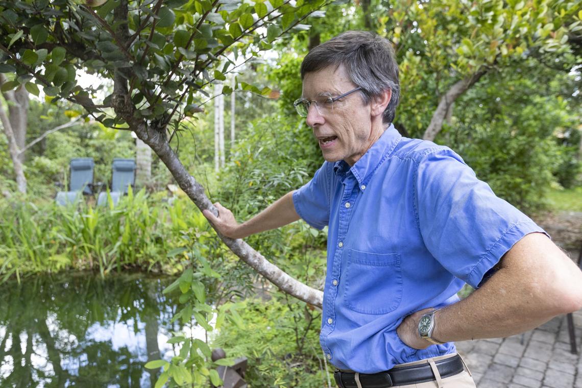 South Miami Mayor Philip Stoddard next to his backyard pond. Stoddard, a proponent of clean energy, disconnected from the FPL grid for a week at his solar- and battery-powered home to test its readiness for hurricane season outages.