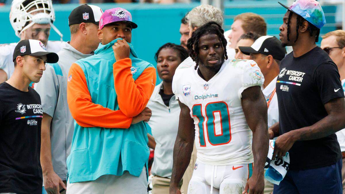 Miami Dolphins quarterback Tua Tagovailoa (1) and teammate Tyreek Hill (10) look from the sidelines during fourth quarter of an NFL football game against the Minnesota Viking at Hard Rock Stadium on Sunday, October 16, 2022 in Miami Gardens, Florida.